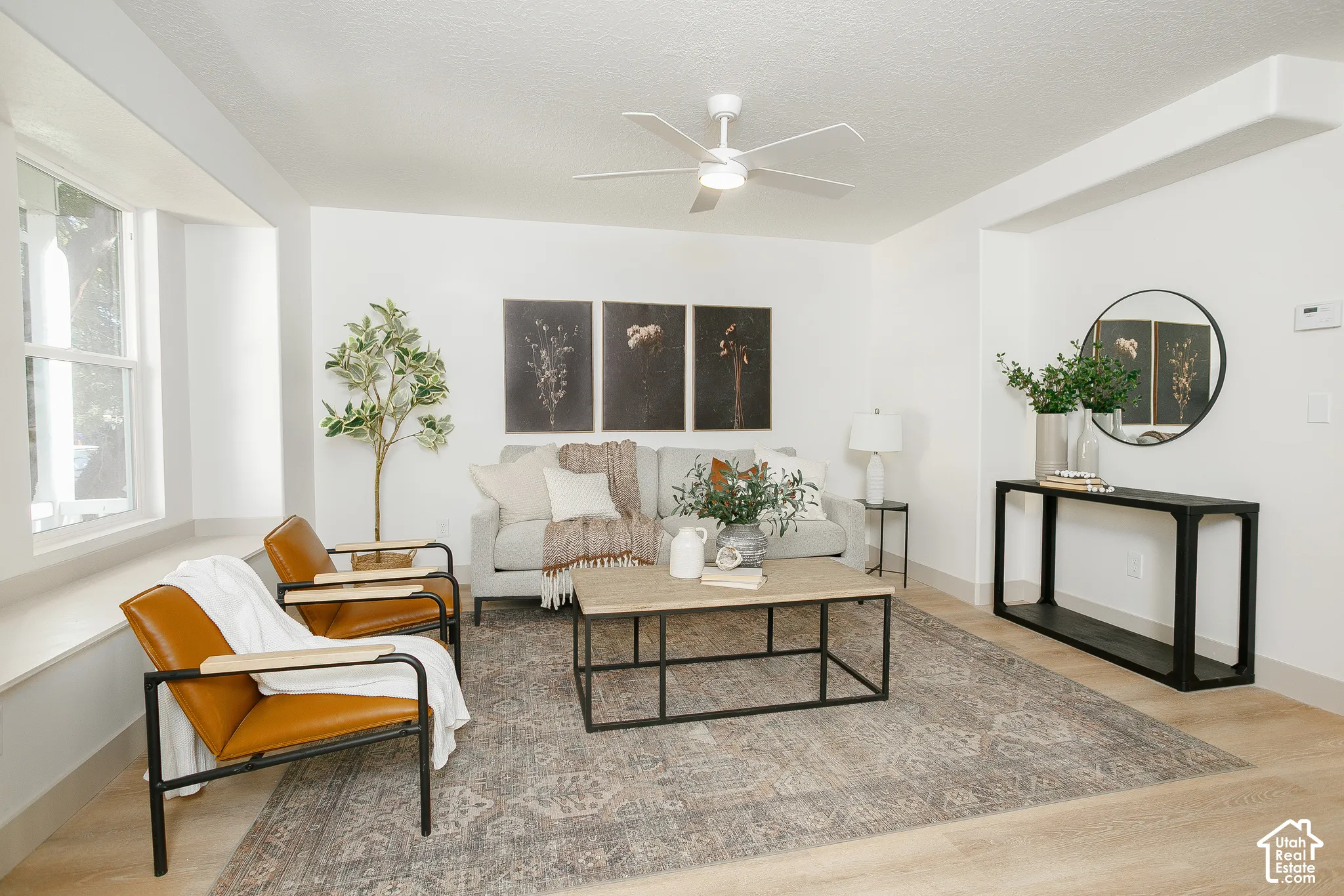Recessed lighting, light wood-finish flooring, a ceiling fan with integrated lighting, and a window with a deep sill