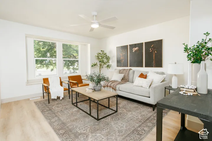 Recessed lighting, wood-finish flooring, ceiling fan, large windows, and white painted walls