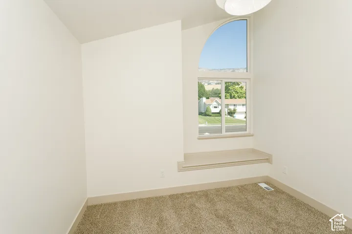 Arched transom window above a fixed pane window, with a built-in window seat