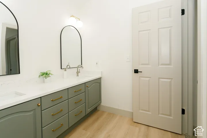 Dual arched mirrors and a vanity with two integrated sinks