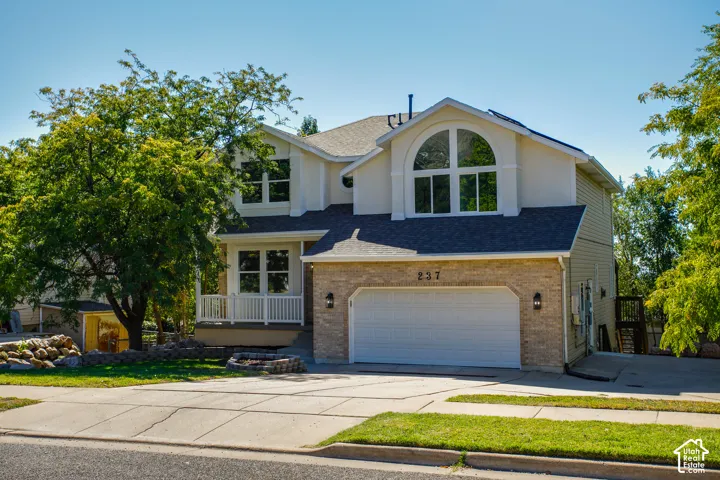 Two-story exterior with light-colored siding and brick accents