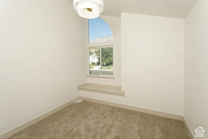 Arched transom window, window seat, recessed window, ceiling-mounted light fixture, carpeting