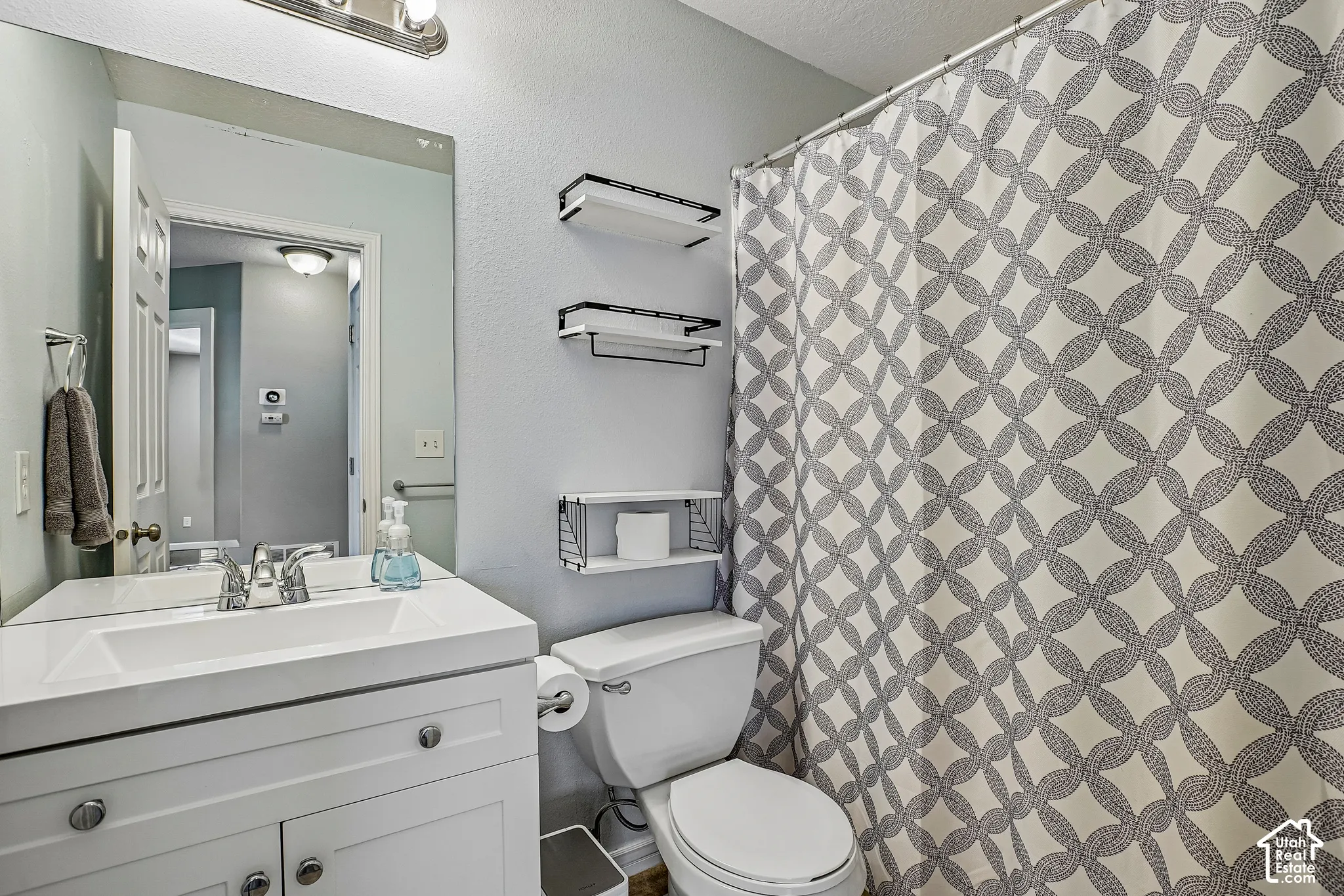 White vanity with an integrated sink and chrome faucet