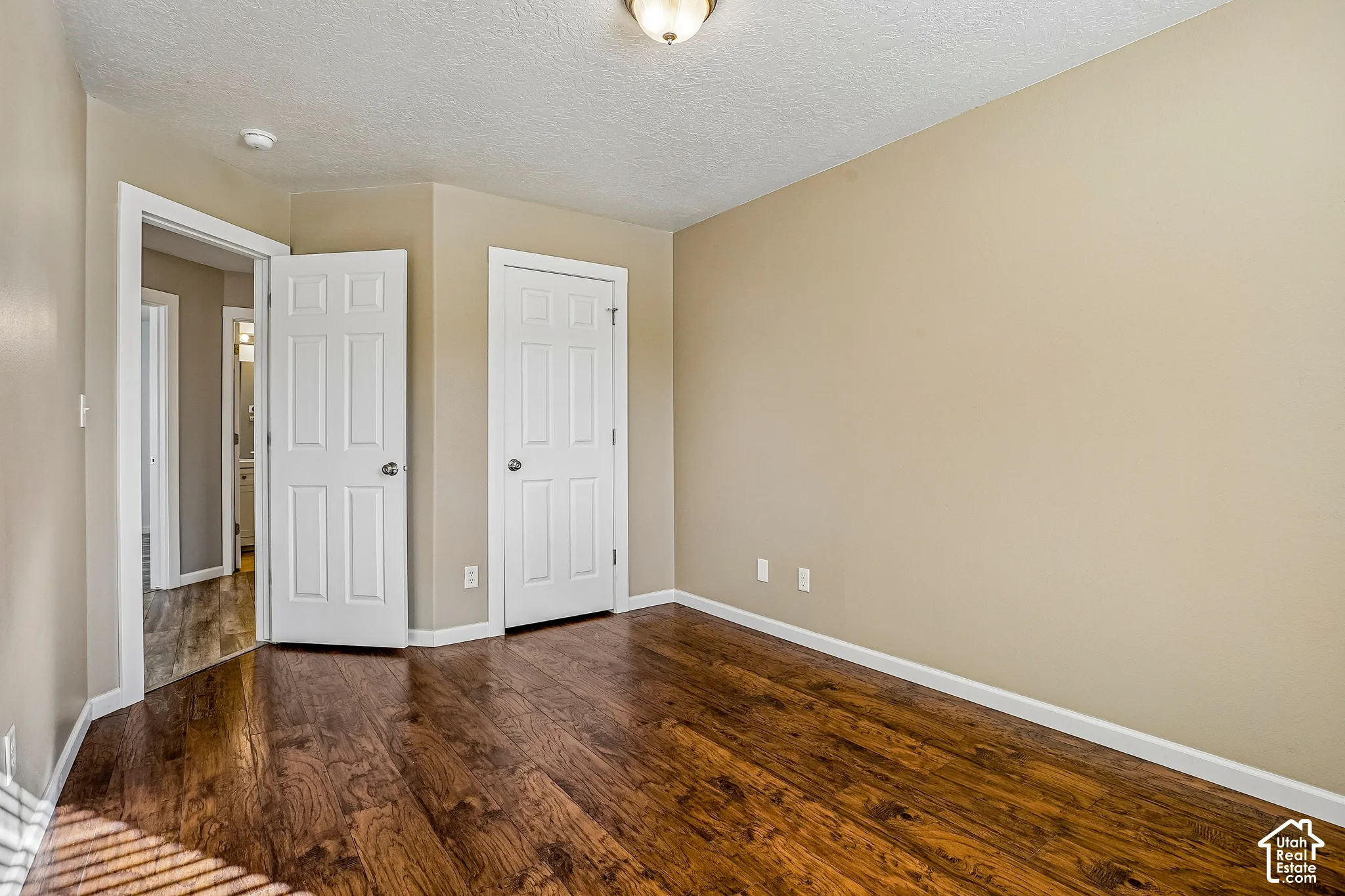 Wood-finish flooring with a neutral wall color and white trim