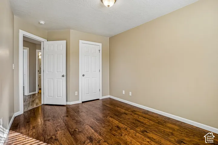 Wood-finish flooring with a neutral wall color and white trim
