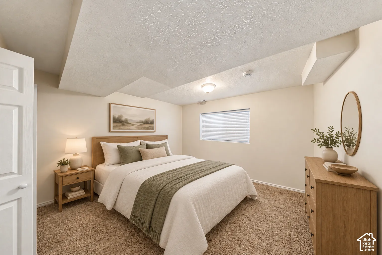 Carpeted flooring, recessed window, ceiling-mounted light fixture, and textured ceiling