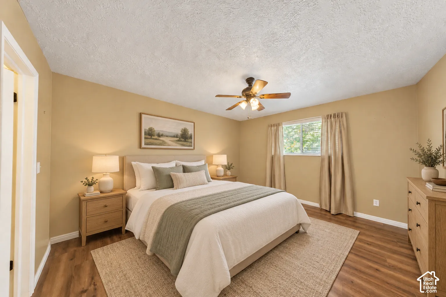 Wood-finish flooring, ceiling fan with integrated lighting, and a window with blinds