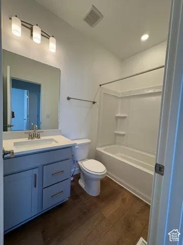 Bathroom 2- Modern bathroom featuring a single vanity with light grey cabinetry, a white countertop, and wood-finish flooring