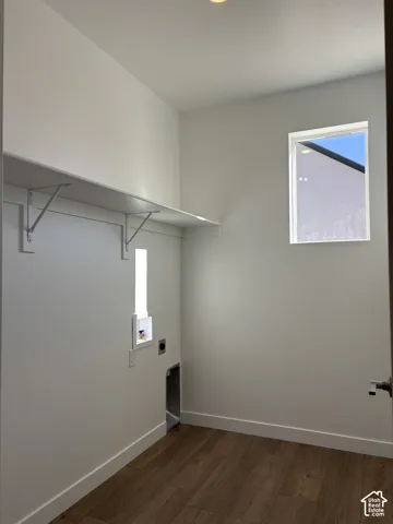 Utility space featuring wood-finish flooring, a fixed window, and a recessed ceiling light