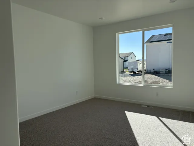 Primary Bedroom with recessed lighting, neutral wall finishes, carpeted flooring, and a large window