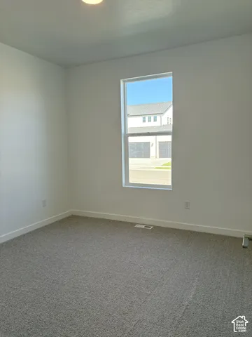 Bedroom 3- Recessed ceiling lighting, neutral carpeting, white walls, and a single window