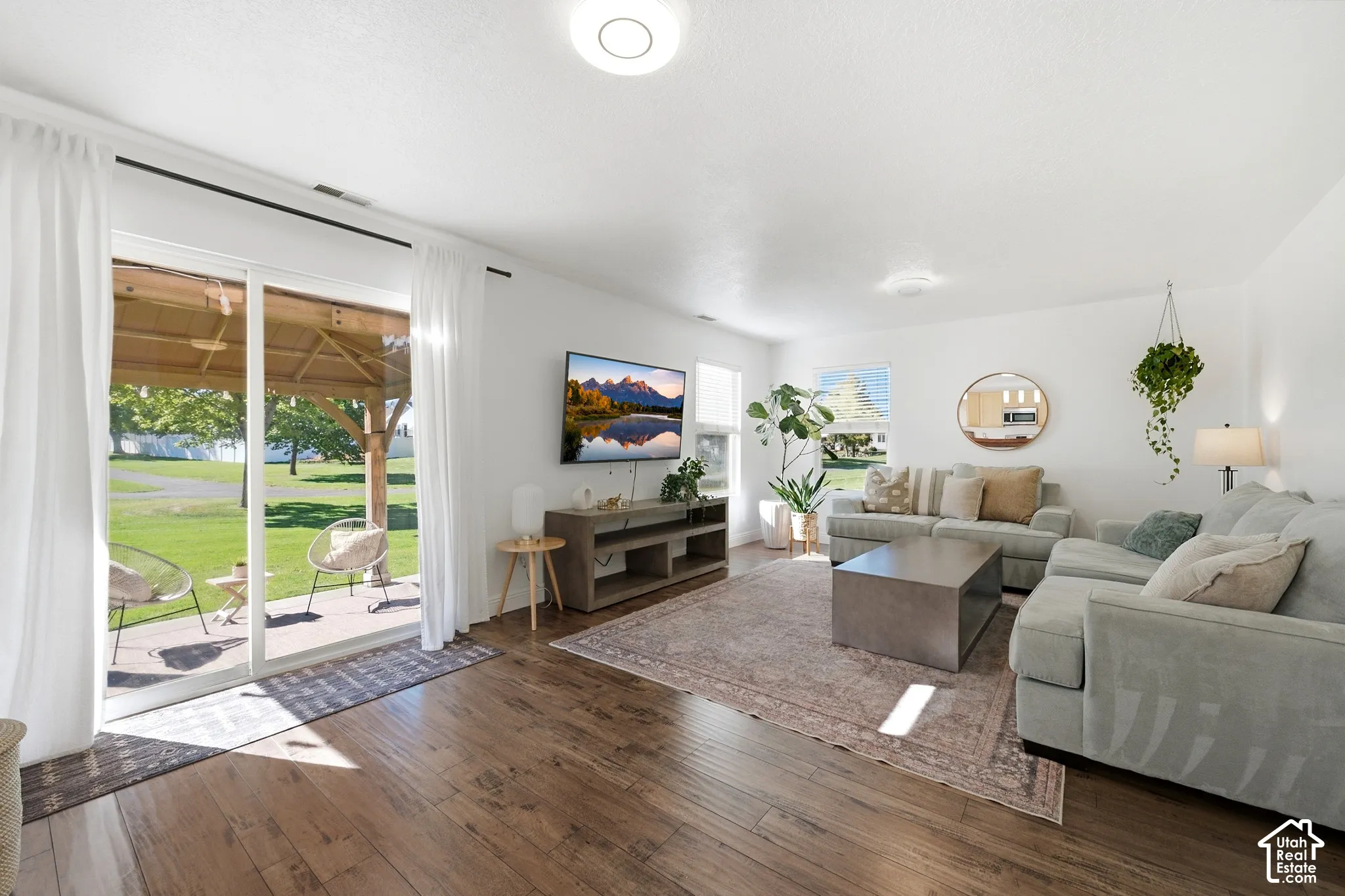 Wood-finish flooring throughout, bright white walls, and a recessed ceiling light
