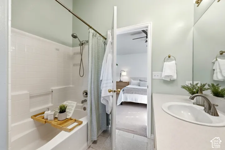 White tile shower-over-tub combination with brushed nickel fixtures