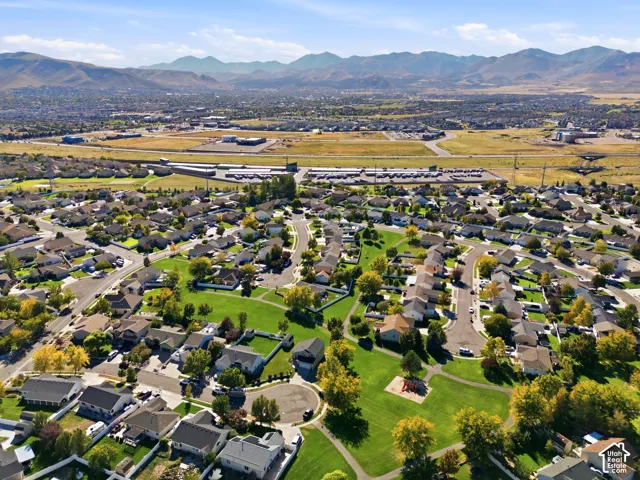 Residential neighborhood featuring a community park with playground equipment and a natural mountain backdrop