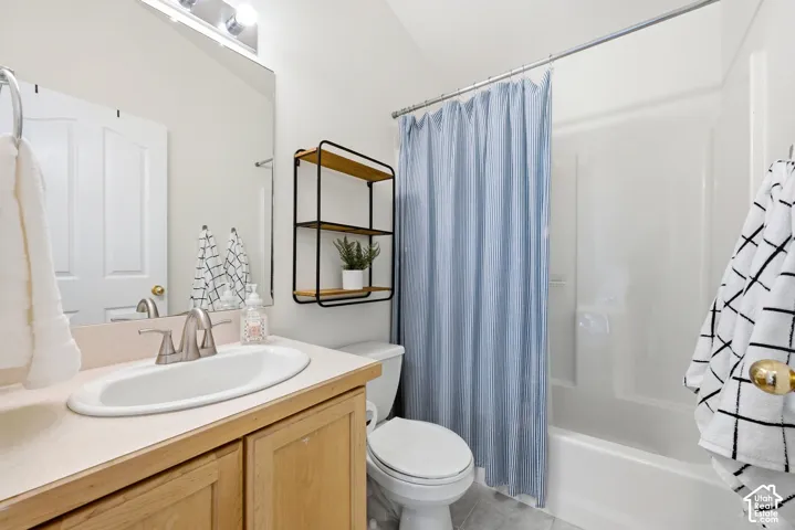Single vanity with wood-finish cabinetry, brushed nickel faucet, and integrated sink