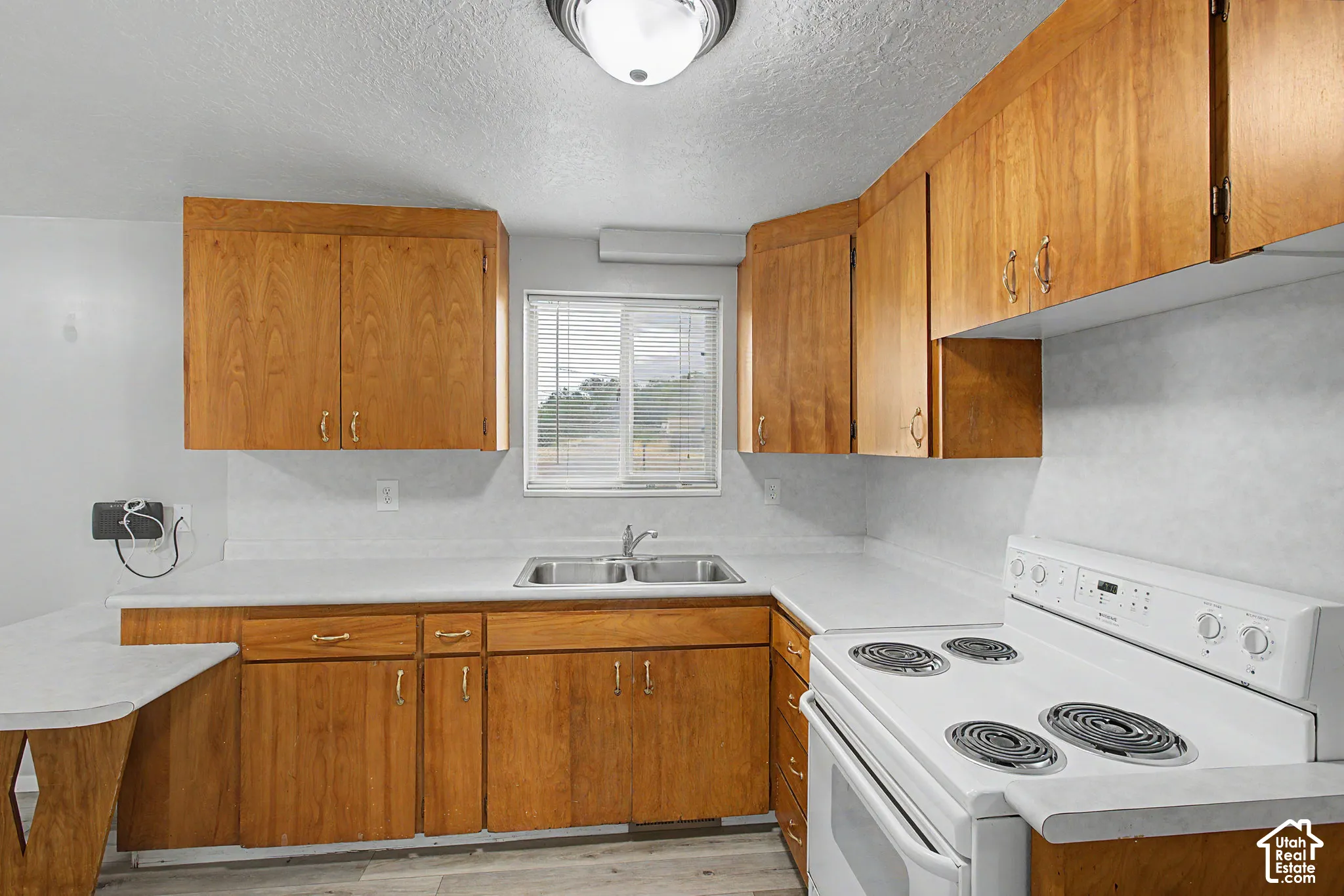 Wood-finish cabinetry paired with light countertops