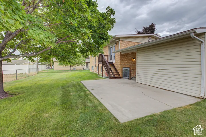 Spacious concrete driveway with attached two-car garage featuring overhead door