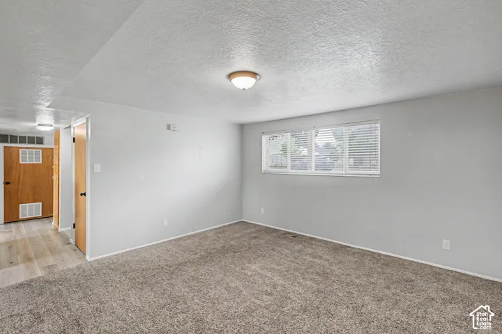 Neutral gray wall paint complementing textured carpet flooring
