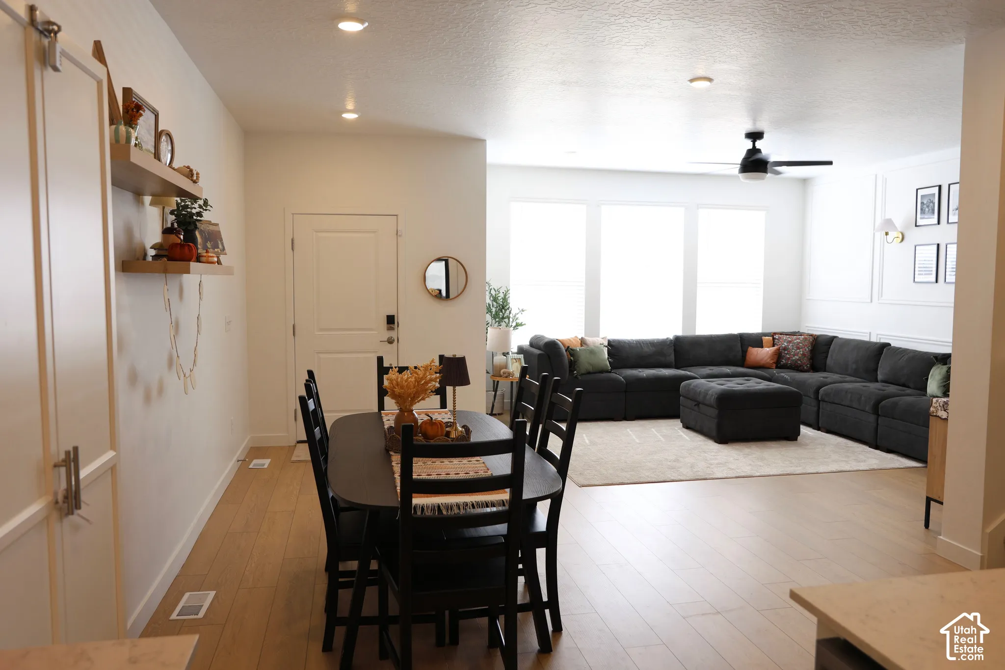 Recessed lighting illuminates wood-finish flooring