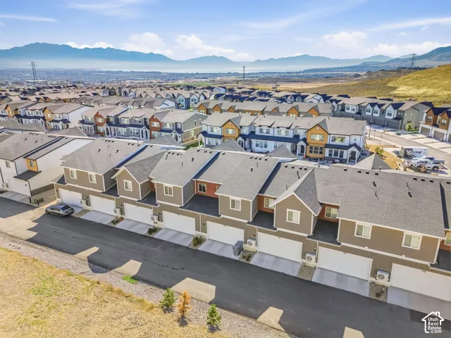 Row of townhomes featuring attached garages and multi-level design