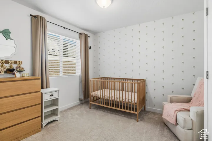 Neutral-toned wall finishes with an accent wall, carpeted flooring, and a ceiling-mounted light fixture