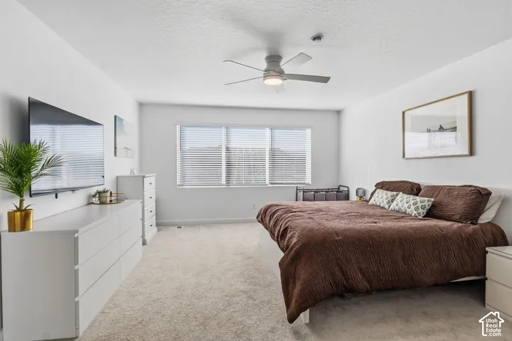Recessed lighting, ceiling fan, carpet flooring, windows with blinds, and white wall finishes
