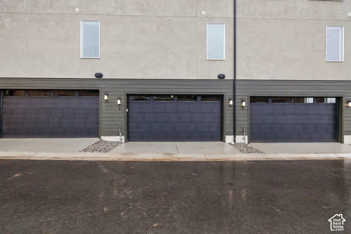 Gray stucco exterior with dark gray siding accents