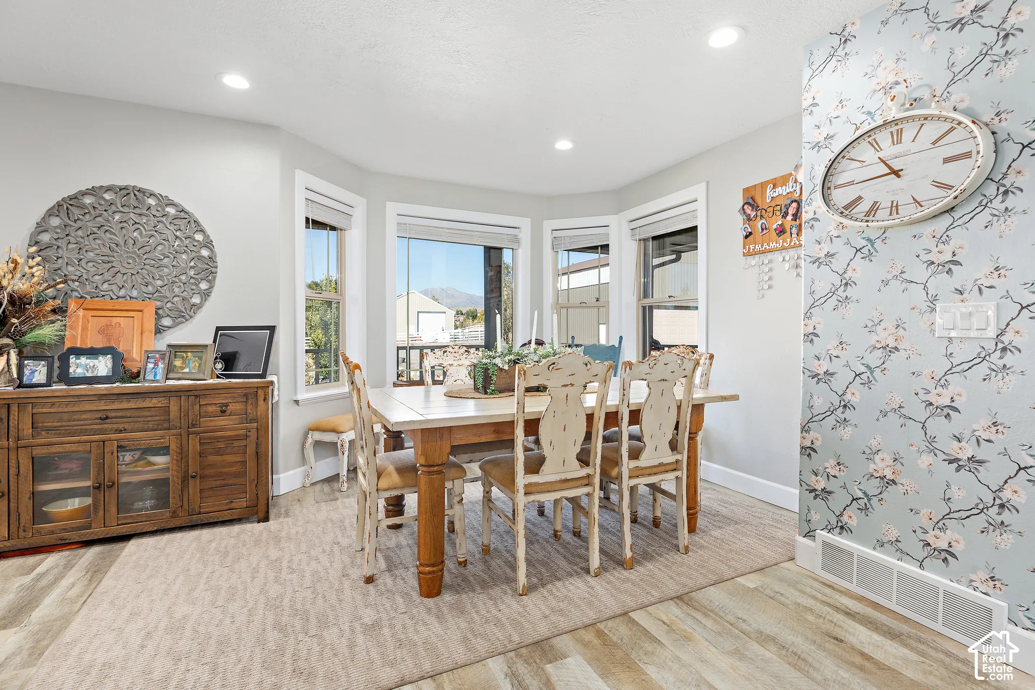 Dining area featuring bay windows, recessed lighting, and wood-finish flooring