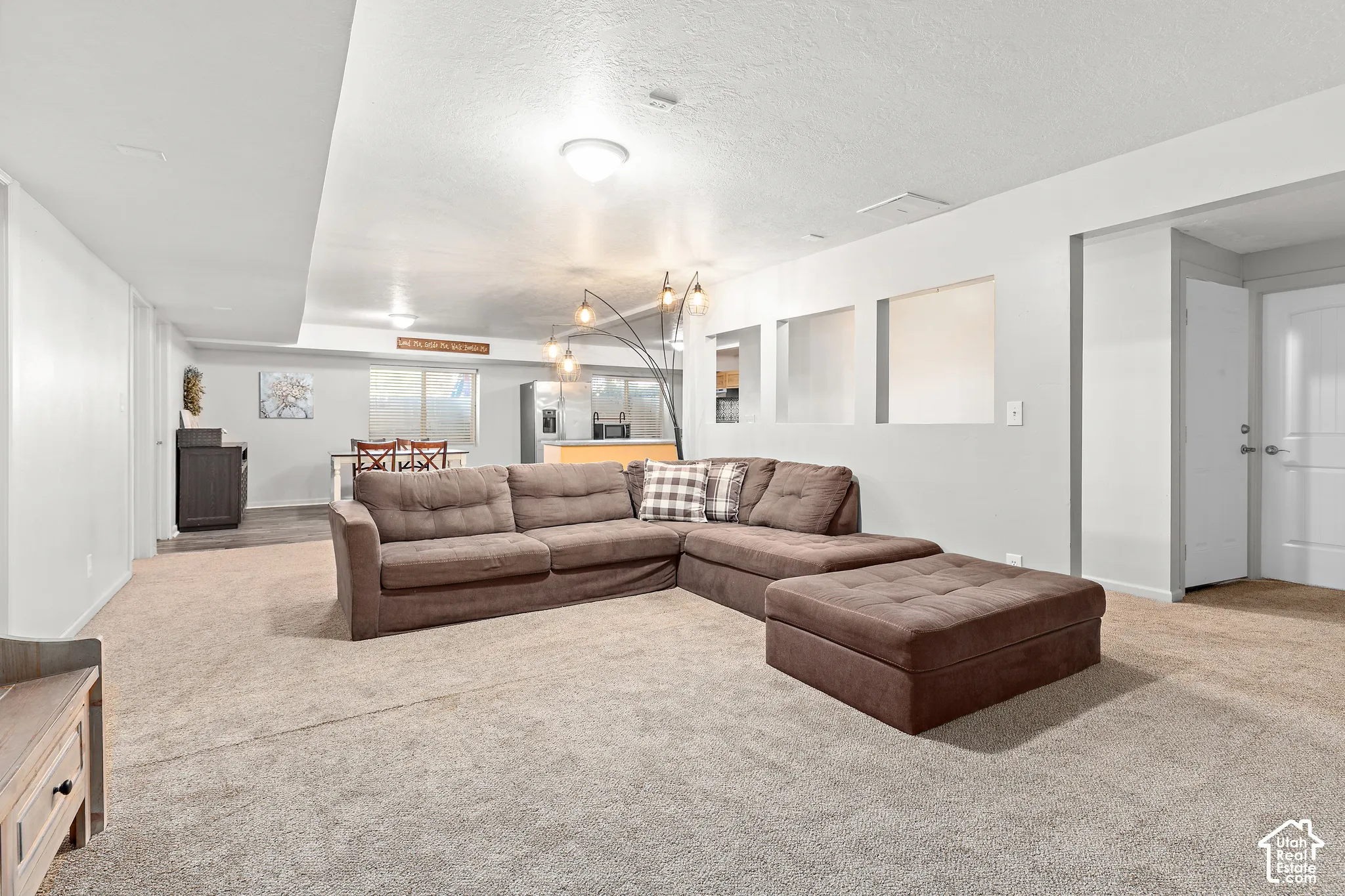 Recessed lighting, light-colored walls, and carpeting
