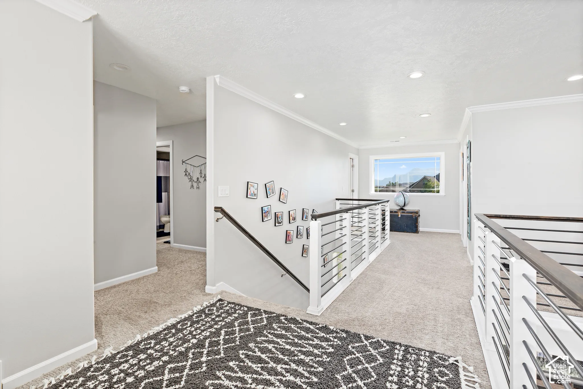 Recessed lighting, light-toned carpeting, white trim, and a window with exterior views