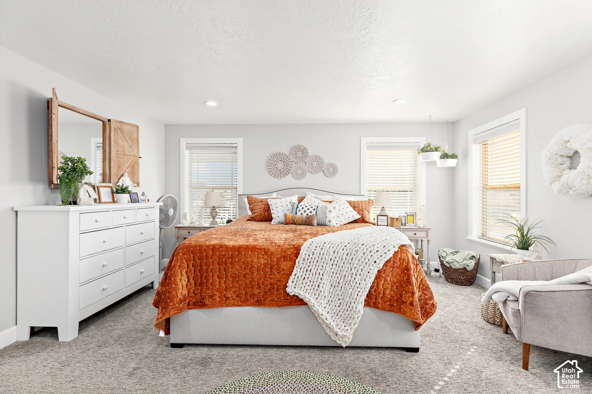Recessed lighting, light gray walls, two windows with blinds, and carpeted flooring