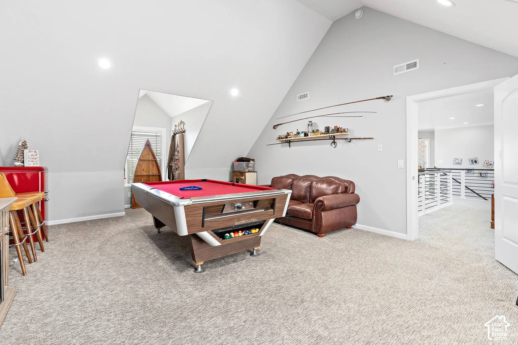 Spacious bonus room featuring sloped ceilings, recessed lighting, and soft carpeting