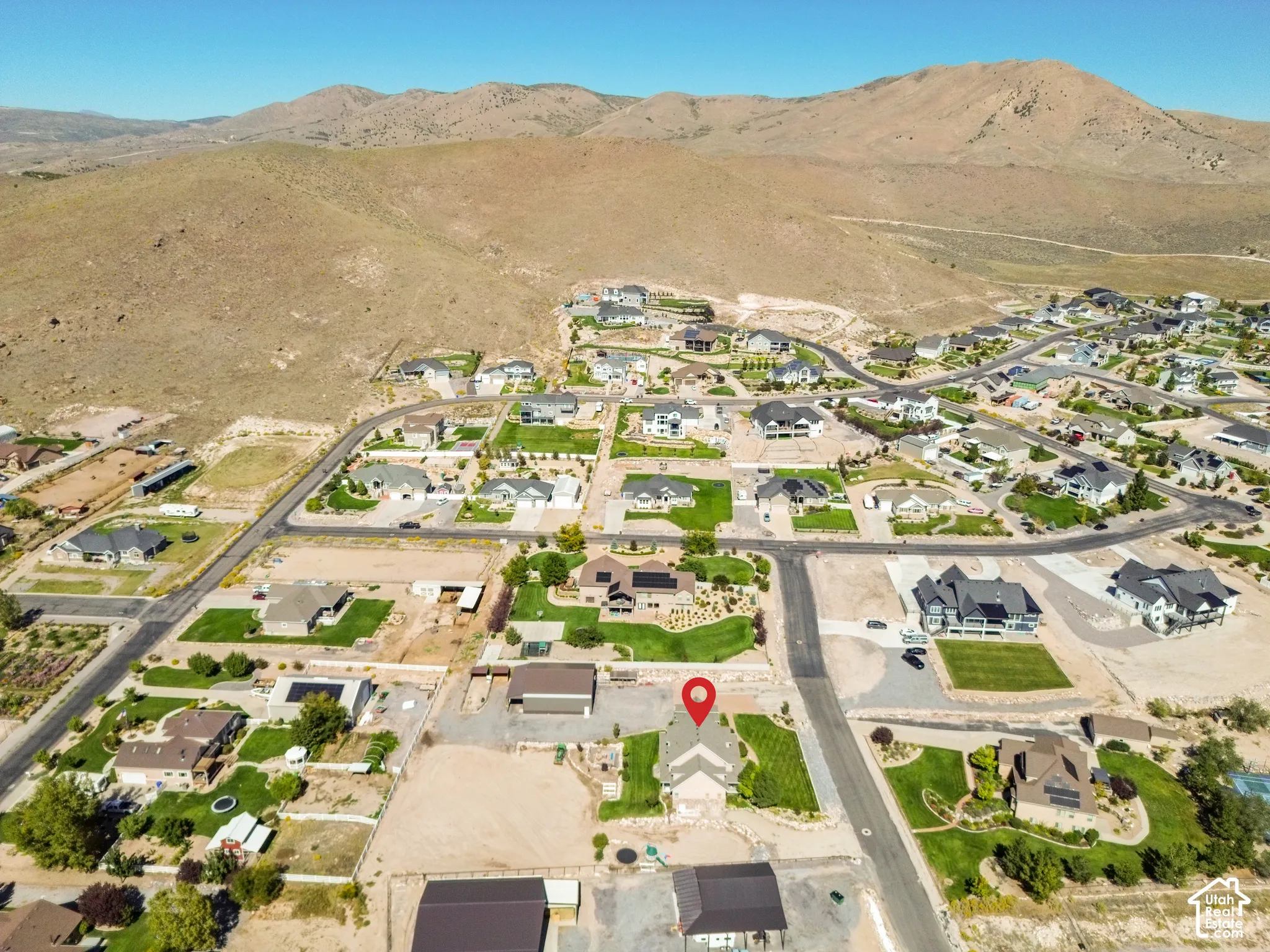 Expansive residential neighborhood with varied architectural styles, nestled against a backdrop of arid mountains