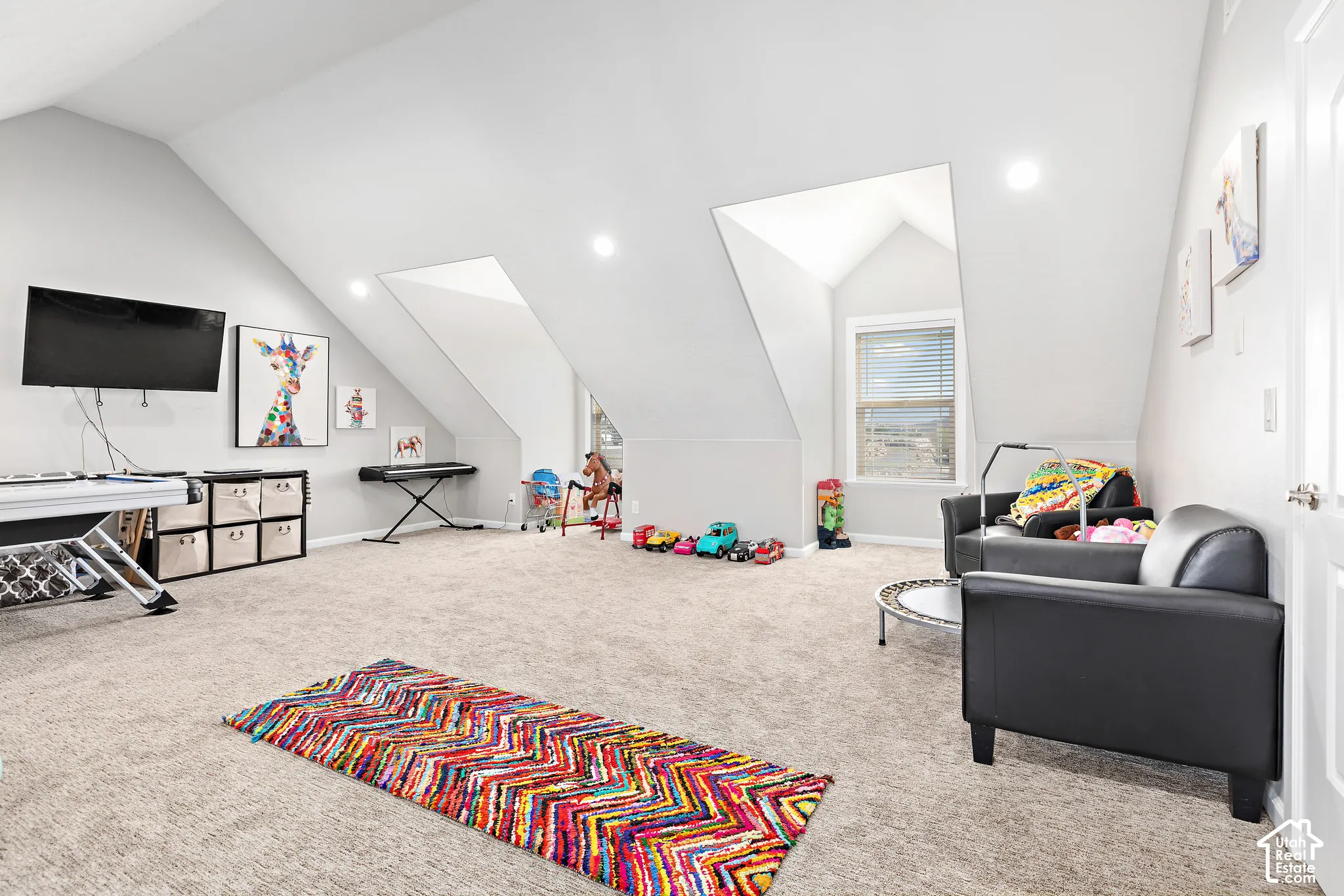 Spacious bonus room featuring sloped ceilings, recessed lighting, and a window with blinds