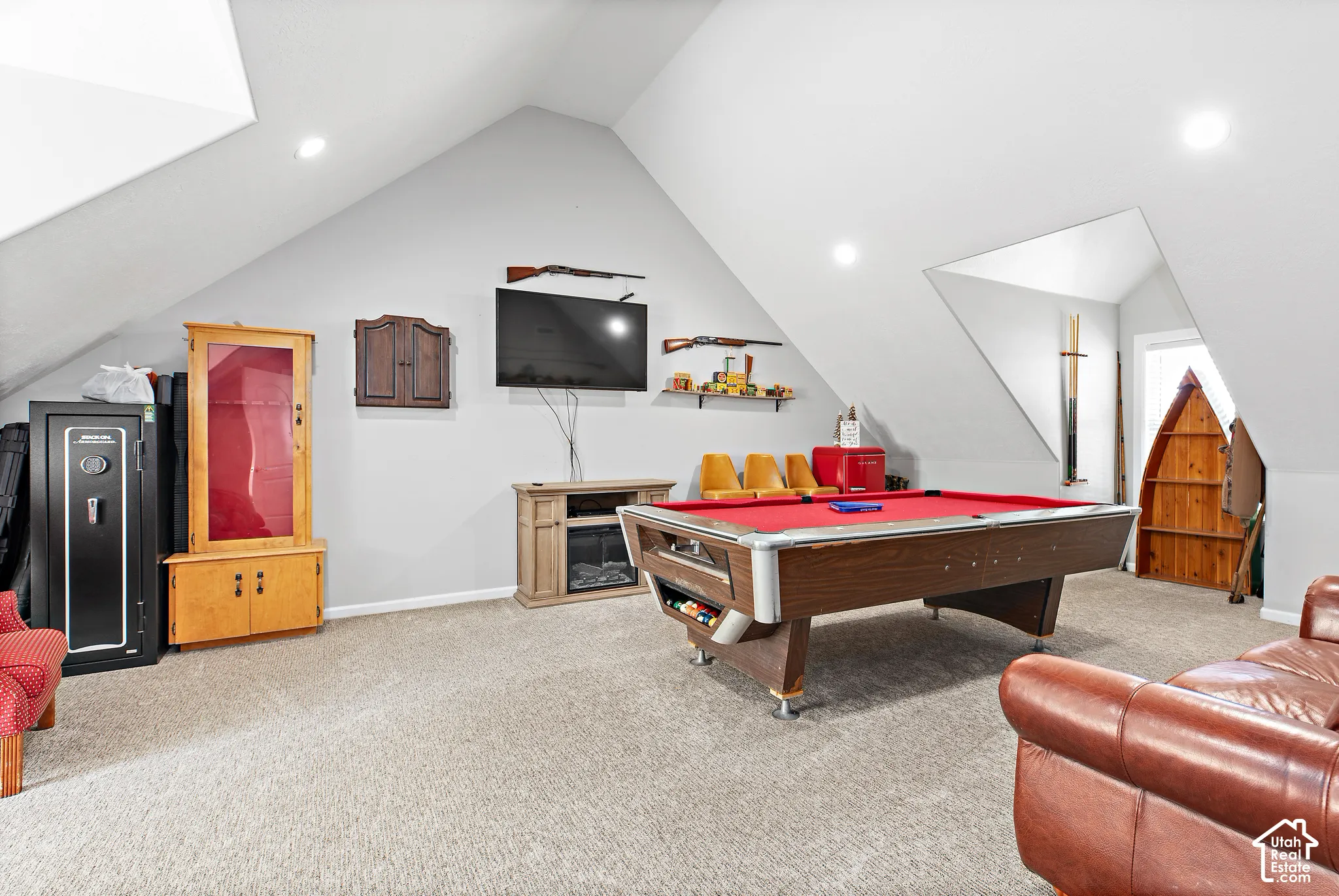 Spacious room featuring vaulted ceilings and recessed lighting
