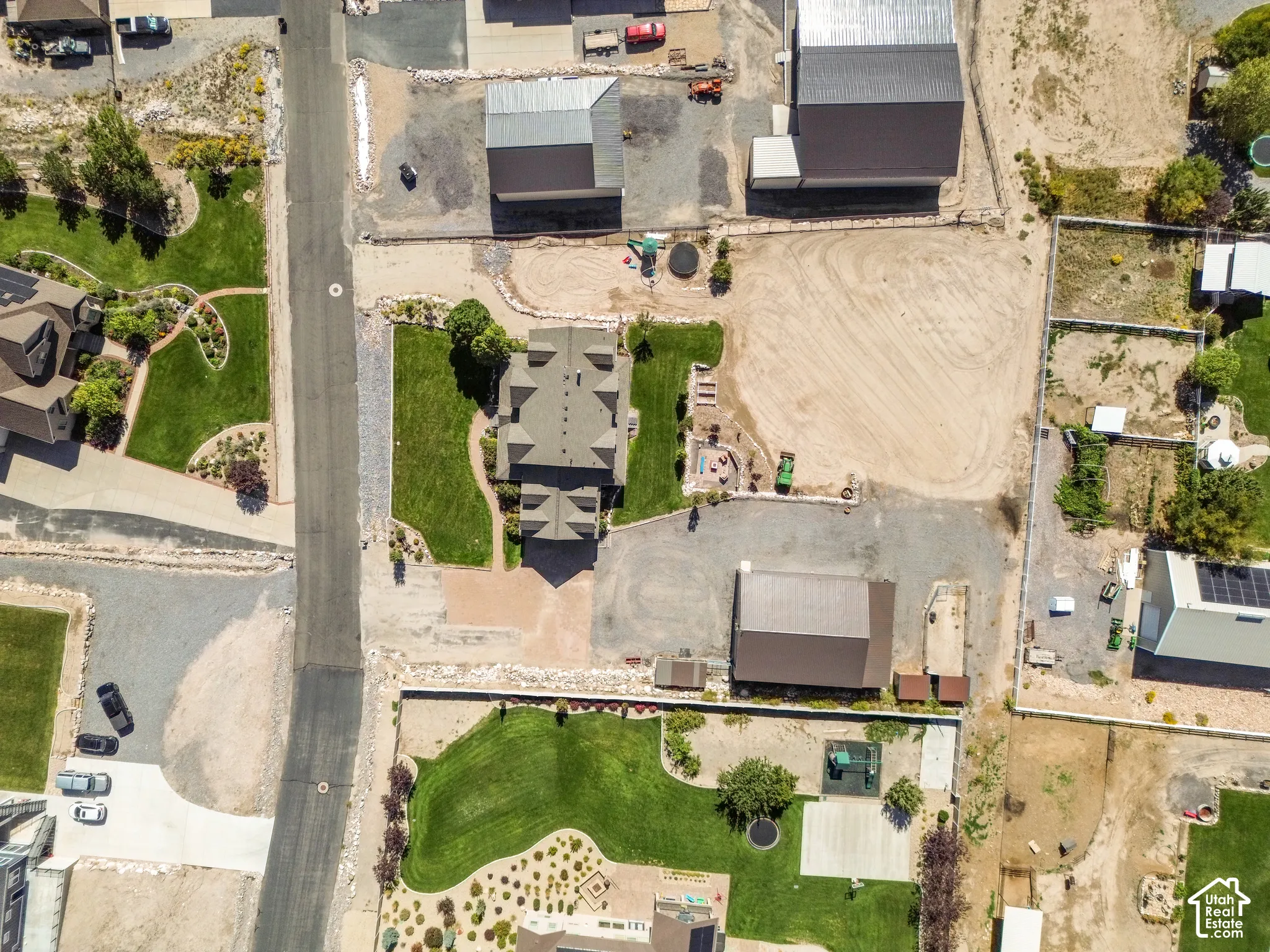 Expansive property featuring a large residence, separate outbuildings, and extensive open ground