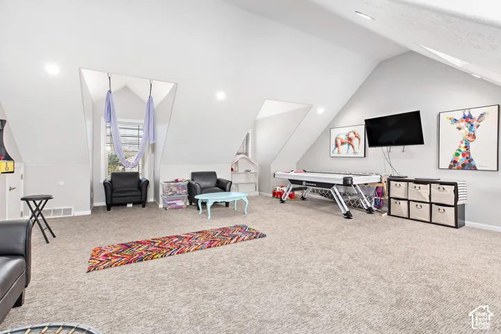 Spacious bonus room featuring dormer windows, recessed lighting, and sloped ceilings