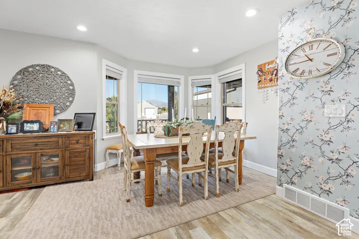 Dining area featuring bay windows, recessed lighting, and wood-finish flooring