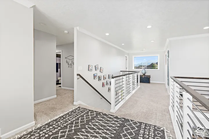 Recessed lighting, light-toned carpeting, white trim, and a window with exterior views