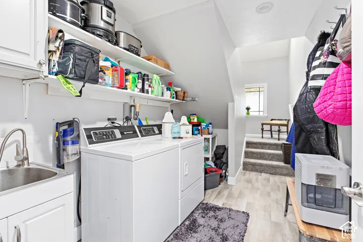 Laundry area with built-in cabinetry, stainless steel utility sink, and wall-mounted shelving