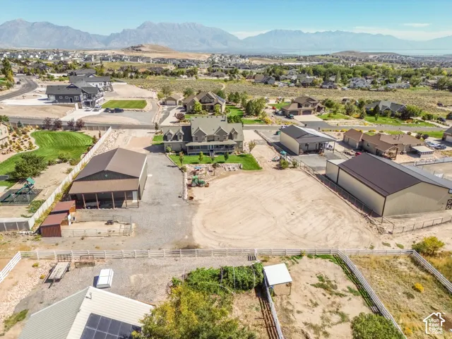 Expansive property featuring a spacious main residence, two large outbuildings, a separate shed, and a fenced perimeter