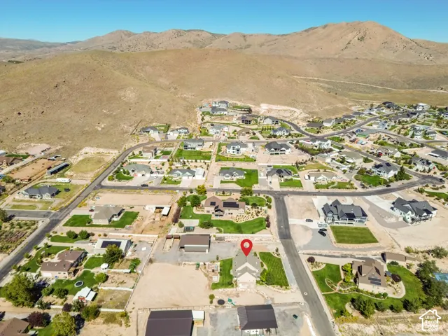 Expansive residential neighborhood with varied architectural styles, nestled against a backdrop of arid mountains