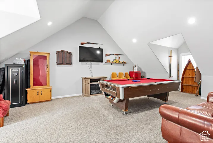 Spacious room featuring vaulted ceilings and recessed lighting