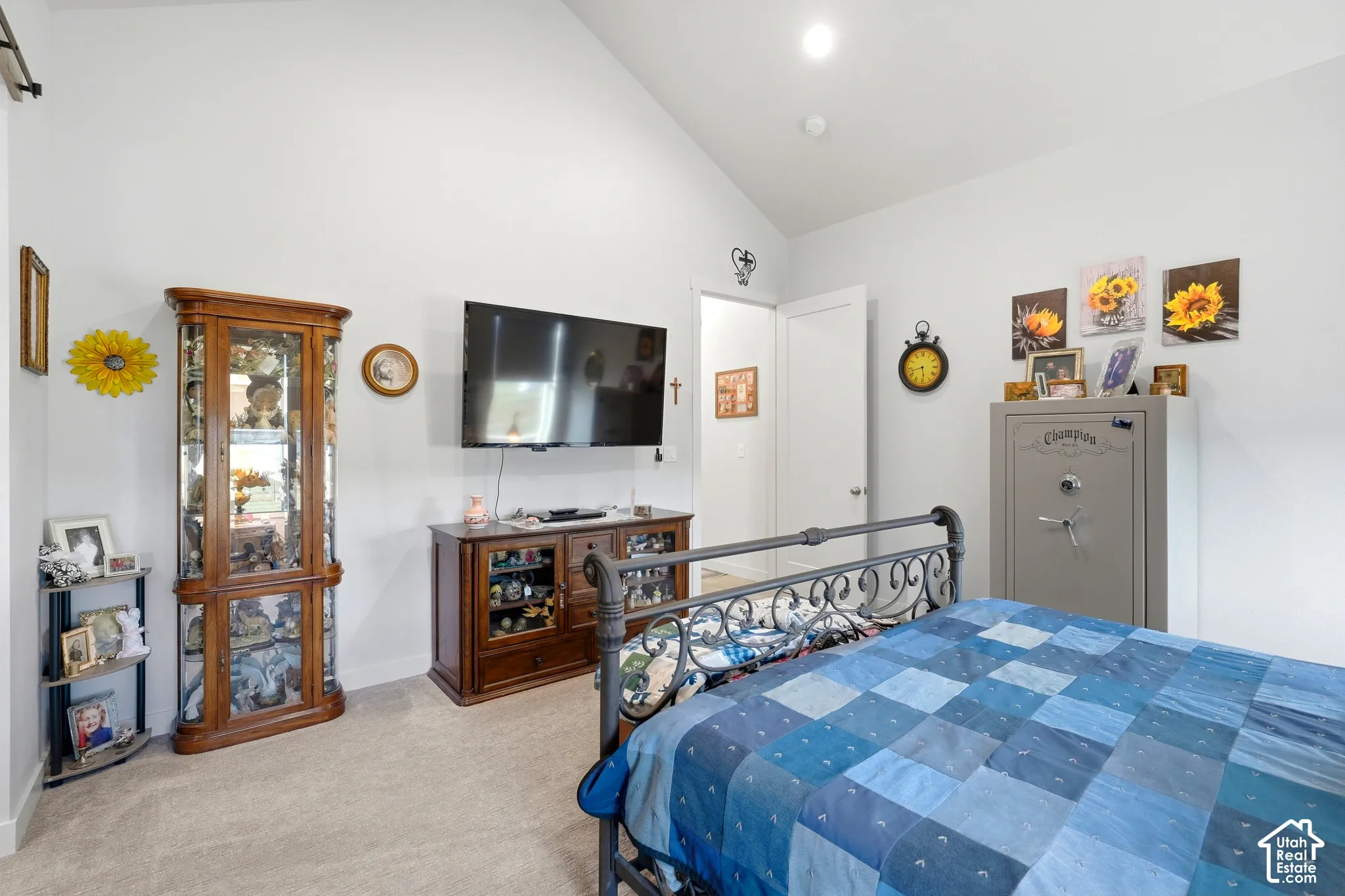 Vaulted ceiling, recessed lighting, carpet flooring, solid core door