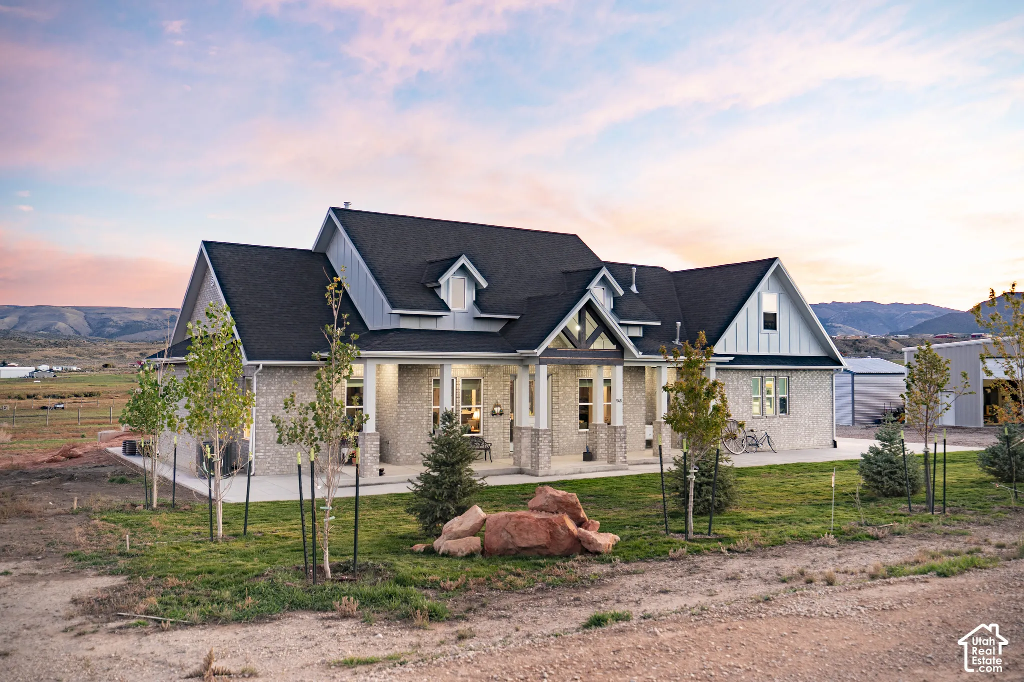 Brick and siding exterior with a dark shingle roof