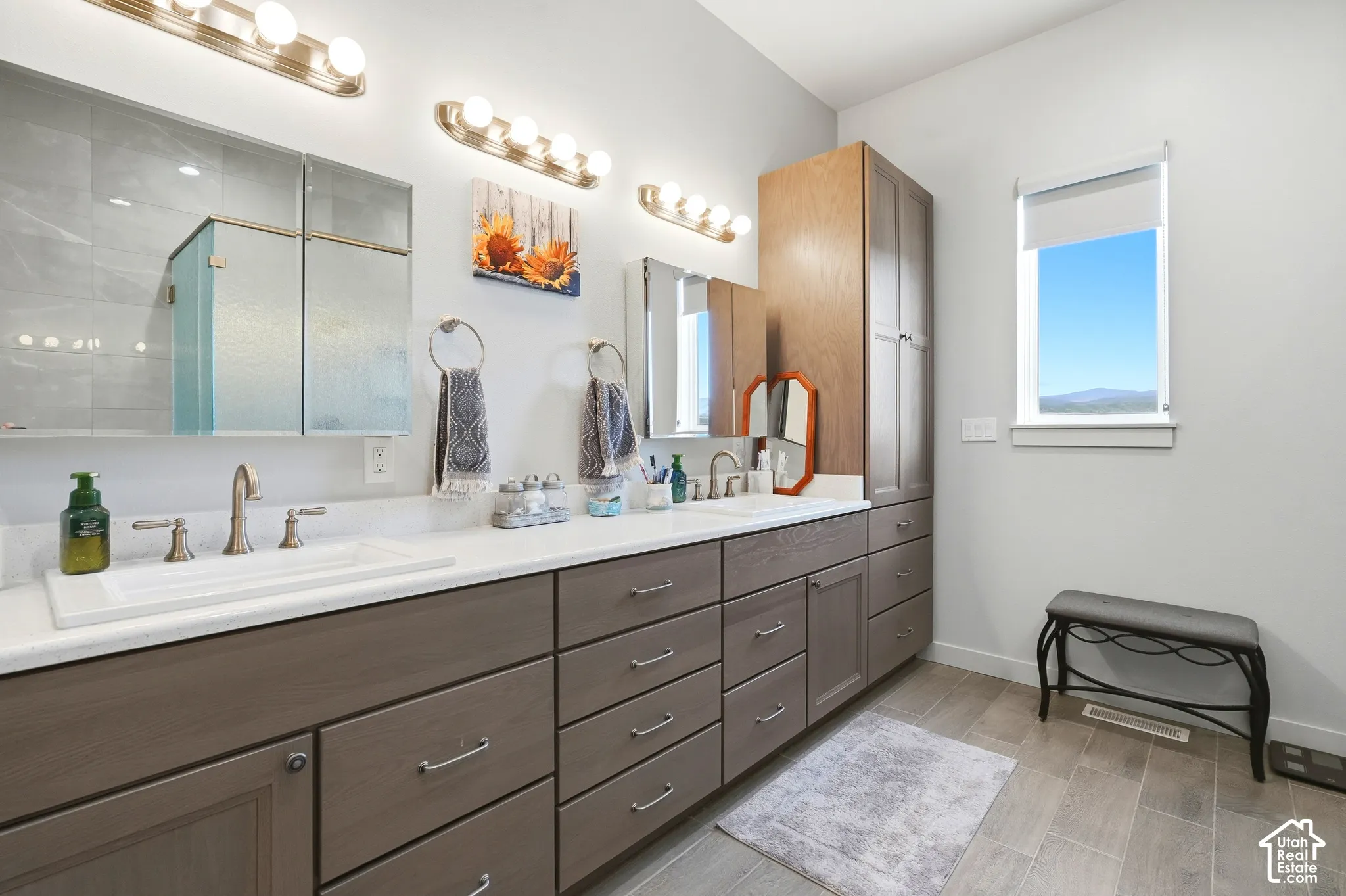Dual vanity with integrated sinks, brushed nickel fixtures, and extensive under-counter storage cabinetry