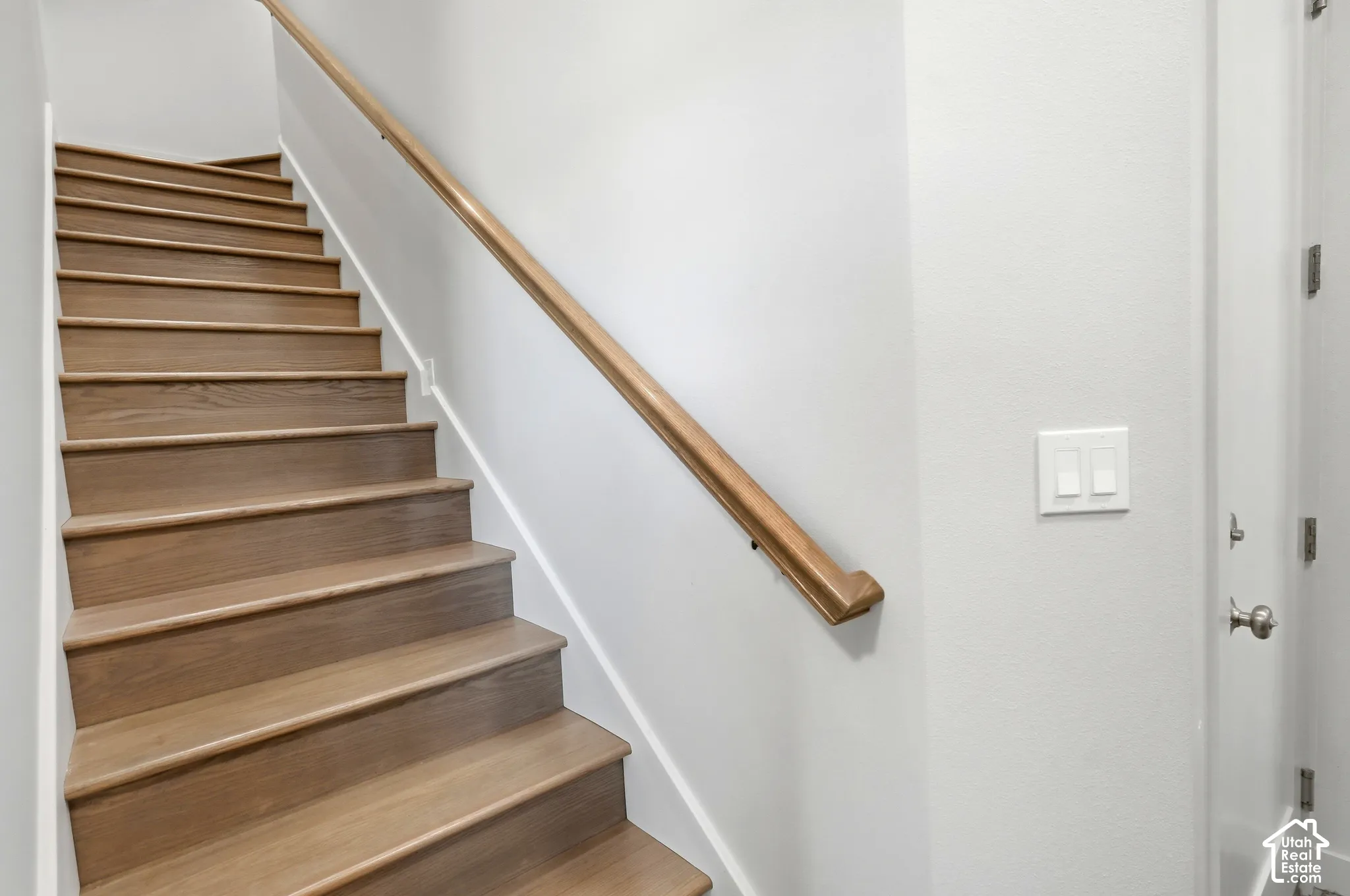 Wood-finish staircase with a natural wood handrail