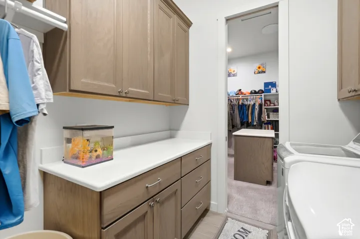 Built-in cabinetry with wood-finish doors and drawers, white countertops, and a clothes hanging rod