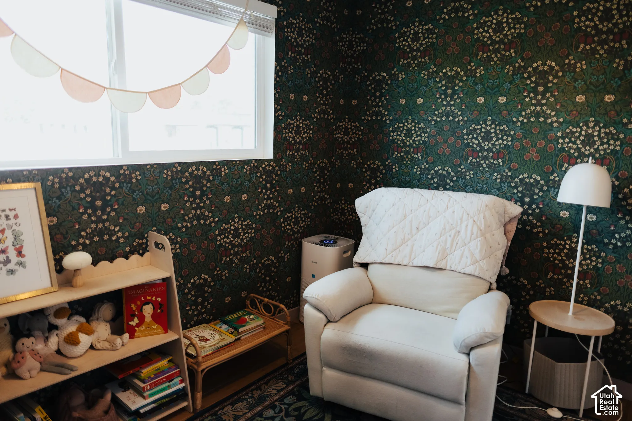 Interior space featuring ornate botanical-print wallpaper and a large horizontal sliding window