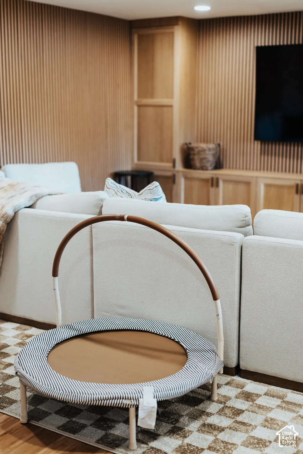 Vertical wood-slat wall paneling, built-in cabinetry, and recessed lighting